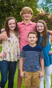Four teen patients standing with arms around each other